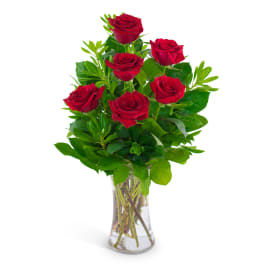 6 red roses in a clear vase