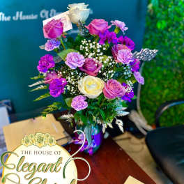 Bouquet of pink, purple, and white roses in a vase