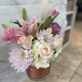 Pink and white bouquet in a copper-toned vase