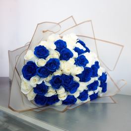 Bouquet of blue and white roses wrapped in clear paper