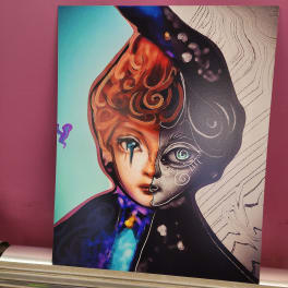 Abstract portrait artwork with a split-color face on a canvas