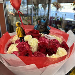 Bouquet of red and cream roses with a red balloon and small figurines