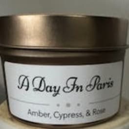 Scented candle in a metal tin with a white label