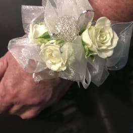 White rose corsage with silver ribbon and mesh bow