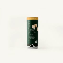 A cylindrical cocktail mixer package with a dark green label on a white background.