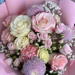 Pink and white rose bouquet with lavender blooms wrapped in pink paper