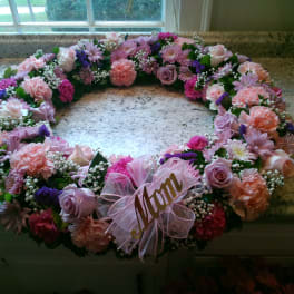 Pink and lavender floral wreath with a ribbon name tag