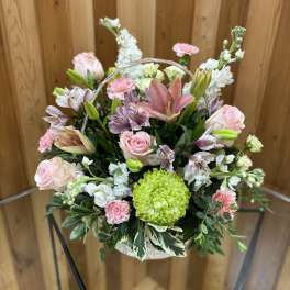 Basket of pink and white flowers with a lime-green bloom