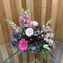 Mixed bouquet with pink gerbera daisies, snapdragons, and purple blooms