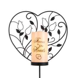 Heart-shaped memorial candle holder with a lit candle