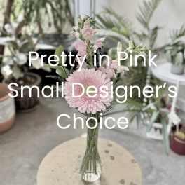 Pink daisy-like flowers in a clear glass vase