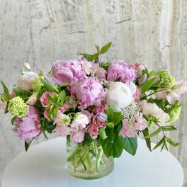 Pink and white mixed flower arrangement in a clear glass vase