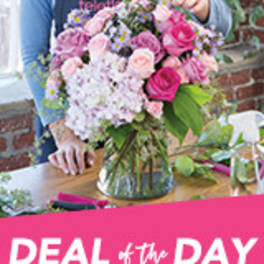 Pink and lavender bouquet in a glass vase on a table