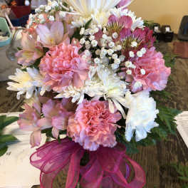 Pink and white mixed bouquet in a glass vase with a magenta ribbon