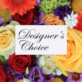 Mixed bouquet of roses and colorful flowers with a Designer's Choice sign