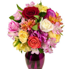 Mixed bouquet of roses and alstroemeria in a purple vase