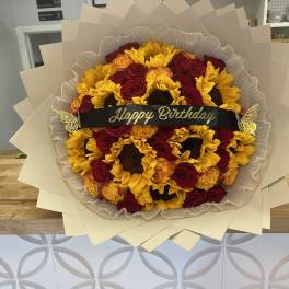 Bouquet of red roses and yellow sunflowers with a Happy Birthday ribbon