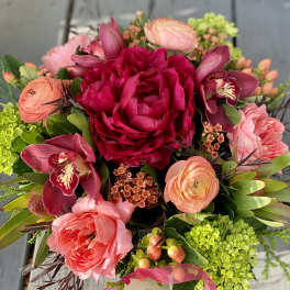 Bouquet of pink and coral flowers with orchids and green hydrangeas
