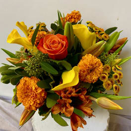 Orange and yellow bouquet with roses, calla lilies, and marigolds