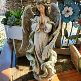 Angel figurine beside a small succulent planter