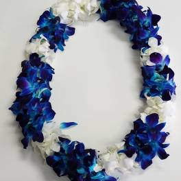 Lei of blue and purple orchids mixed with white blossoms in an oval shape