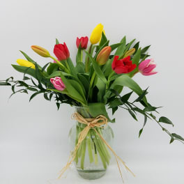 Bouquet of multicolored tulips in a glass vase