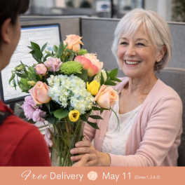 Mixed bouquet of pastel roses, hydrangea, and chrysanthemums in a glass vase