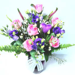 Pink and purple mixed bouquet in a vase with lace ribbon