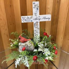 Memorial cross arrangement with red flowers and greenery