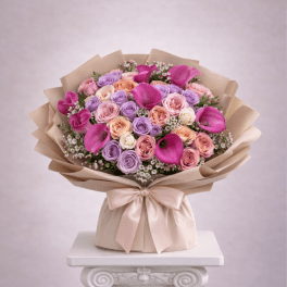 Bouquet of pink, lavender, and peach roses with magenta calla lilies