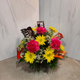 Bouquet of yellow daisies and pink carnations with candy bars