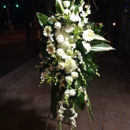 Tall white floral standing spray on an easel