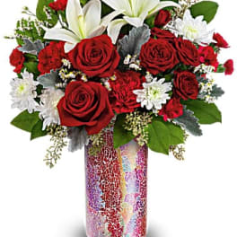 Red roses and white lilies in a mosaic glass vase