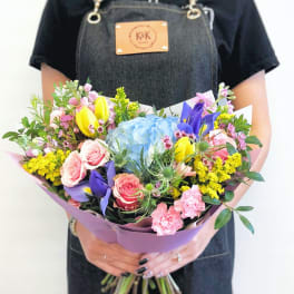 Handheld bouquet with roses, hydrangea, tulips, and purple iris