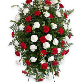 Standing floral spray with red and white carnations on an easel