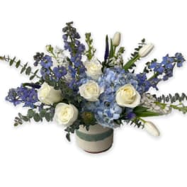 Blue and white floral arrangement in a ceramic vase
