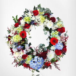 Round wreath of red, white, blue, and green flowers in a full ring design