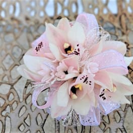 Small pink and white orchid corsage with ribbon accents
