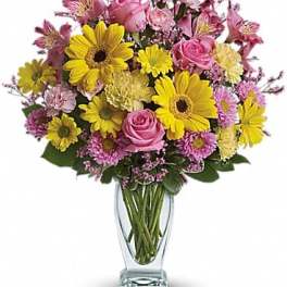 Pink and yellow mixed bouquet in a clear glass vase
