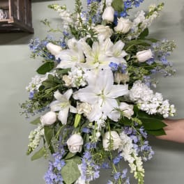 Large bouquet of white lilies and blue flowers