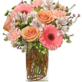 Pink and peach mixed bouquet in a clear rectangular vase