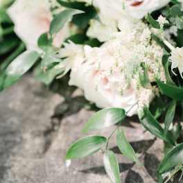 Blush roses with white filler flowers and greenery