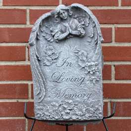 Gray memorial plaque with angel relief and the words In Loving Memory