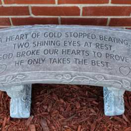 Gray memorial bench with an engraved sympathy poem