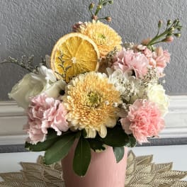Pink and white bouquet with yellow chrysanthemums in a pink vase
