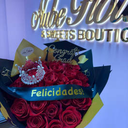 Bouquet of red roses with a small crown and graduation topper
