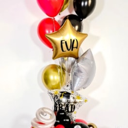Graduation balloon tower with black, gold, red, and silver balloons