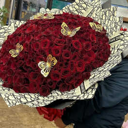 Large bouquet of deep red roses with decorative butterfly picks