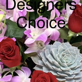 Red roses and purple orchids with a pale blue succulent