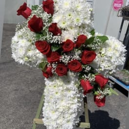 Standing cross arrangement of red roses and white chrysanthemums